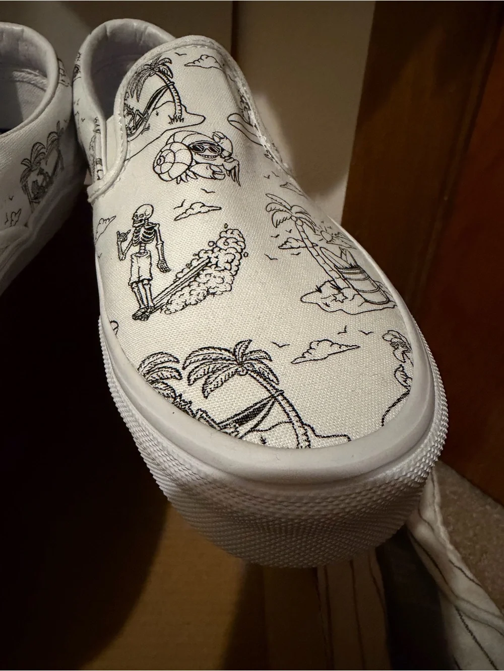 Vans White Slip-On Sneakers with Black skeleton doodles